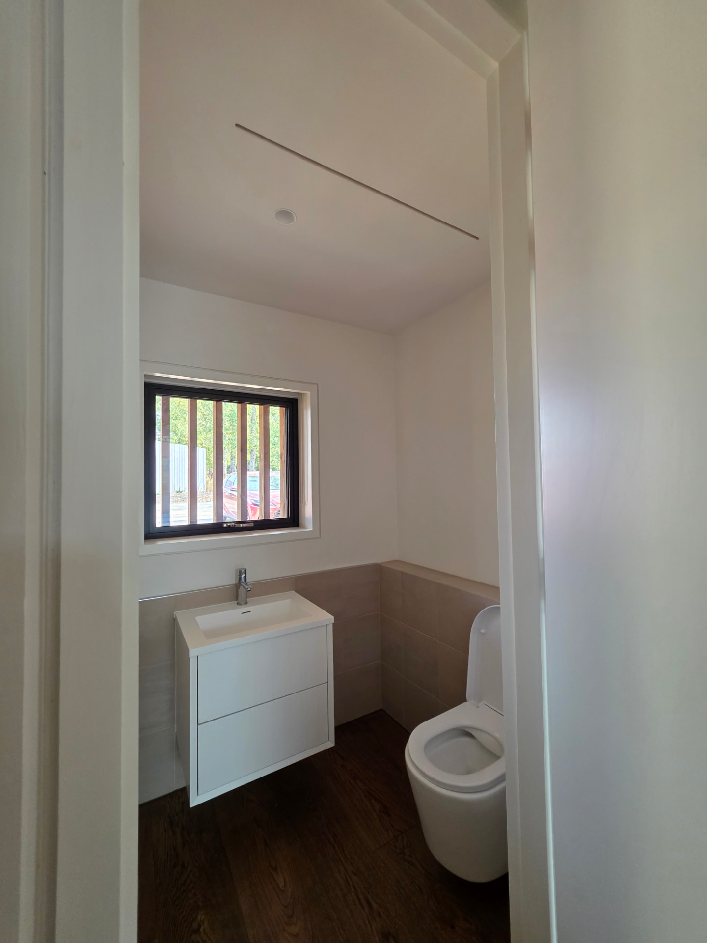 Cloakroom with a flush ceiling extract valve and linear vent